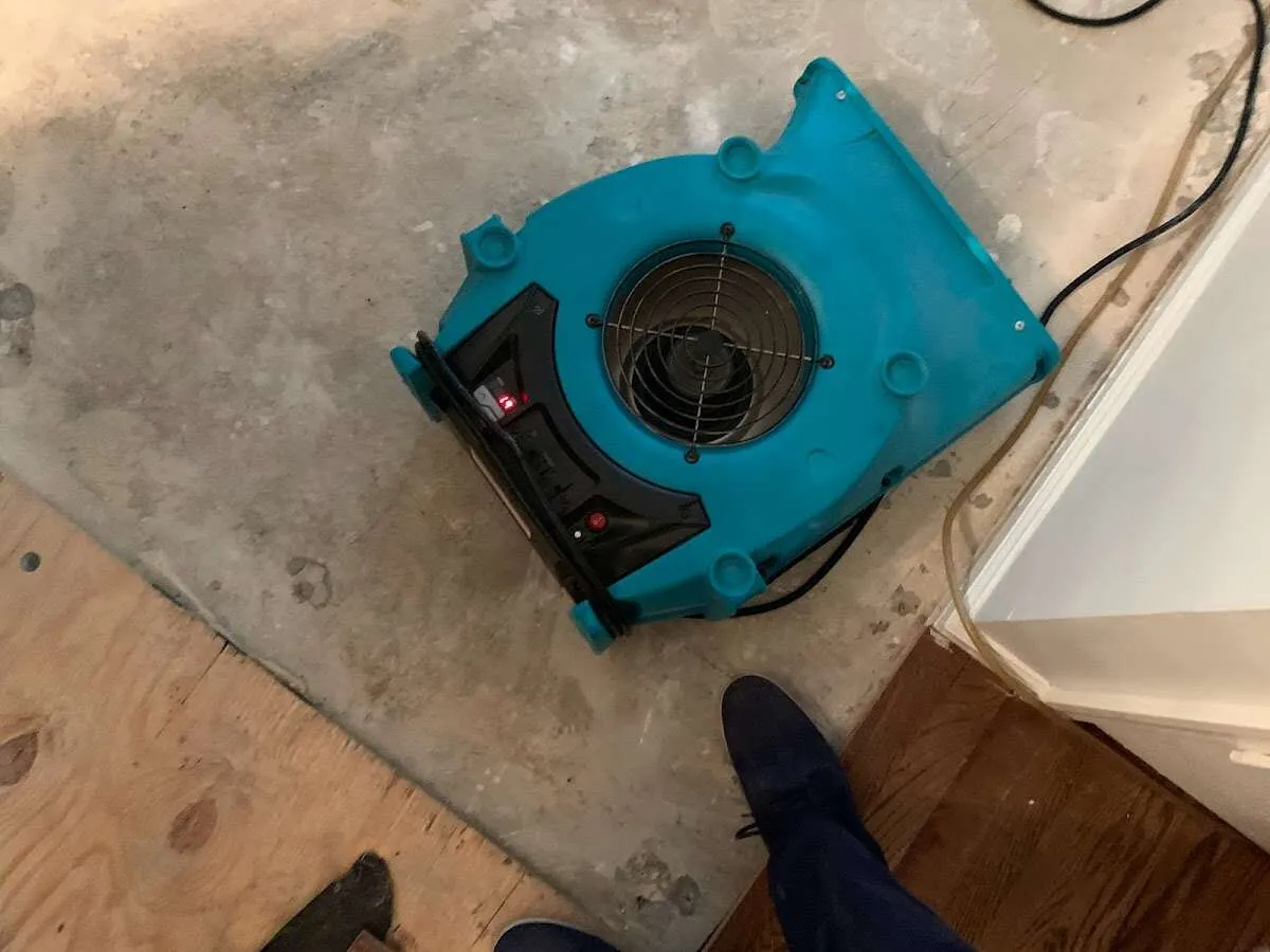 Air mover drying subfloor during Commercial Water Damage Restoration in Englewood Cliffs